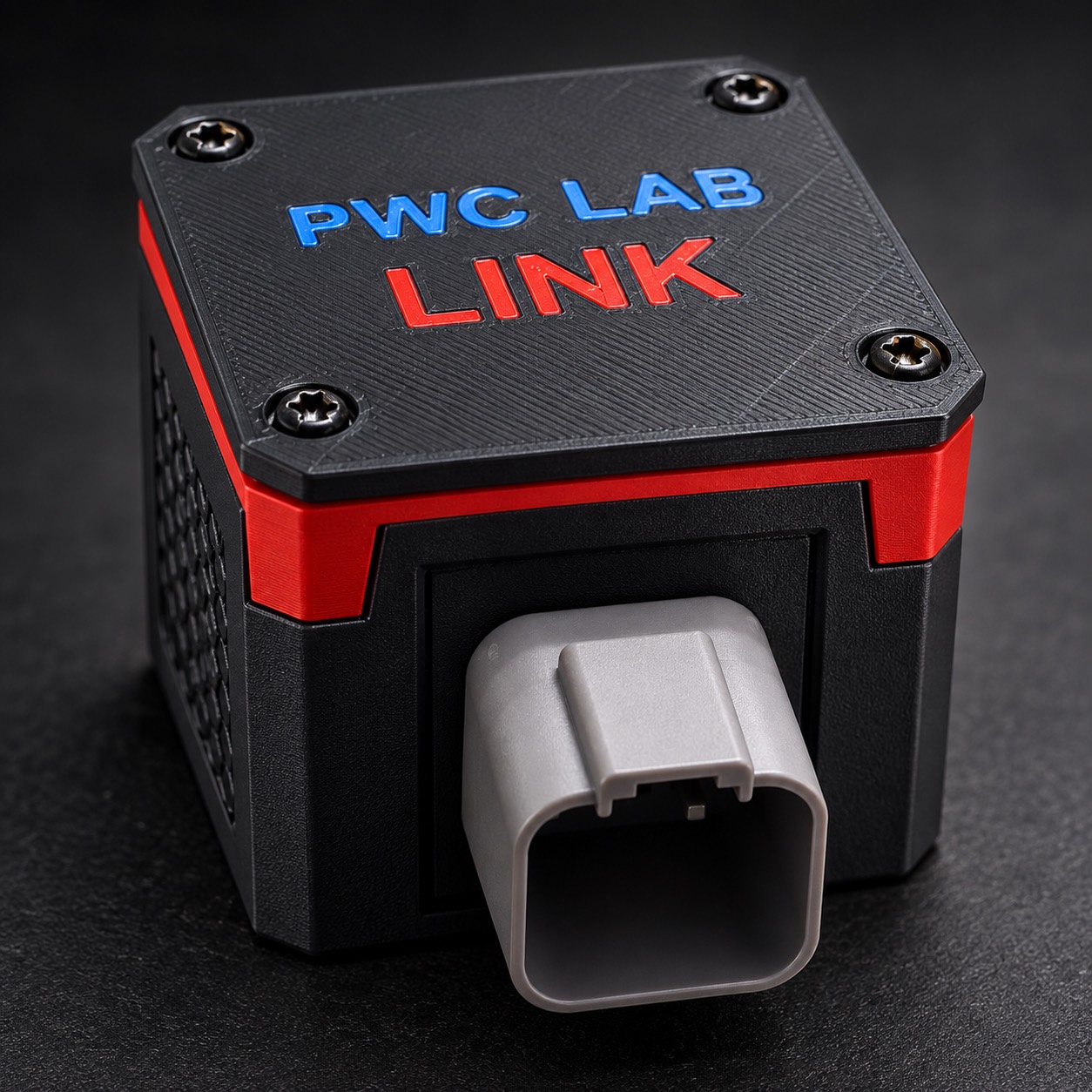 Single-plug PWC LAB Link with its gray connector, red band, textured black enclosure and blue PWC LAB and red LINK lettering